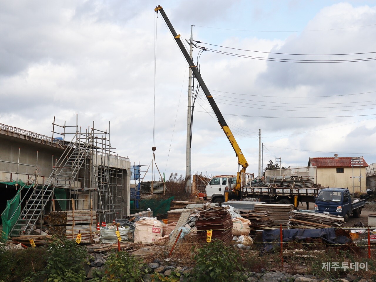 지난해 12월 2일 민군복합형 관광미항(제주해군기지) 진입도로 개설 공사 현장을 찾았다. 포크레인이 건축 자재를 옮기고 있다. (사진=박지희 기자)