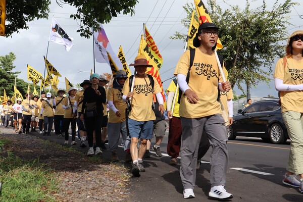 22일 서귀포시 강정동 제주해군기지에서 제주시청까지 걷는 '2024 제주생명평화대행진'이 진행된 가운데, 100여명의 참가자들이 해군기지 정문에서 남원읍까지 행진하고 있다. (사진=박지희 기자)