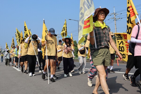 23일 '2024 제주생명평화대행진'이 2일차에 접어든 가운데, 100여명의 참여자들이 서귀포시 남원읍 태흥리 거리를 행진하고 있다. (사진=박지희 기자)